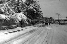 Snowy day on Bethlehem Road in Upper Baq'a not far from the railroad crossing. The Krikorian home was in the foreground on the left. You can see the German Hospice of St. Charles straight ahead, Jerusalem, early 1940's